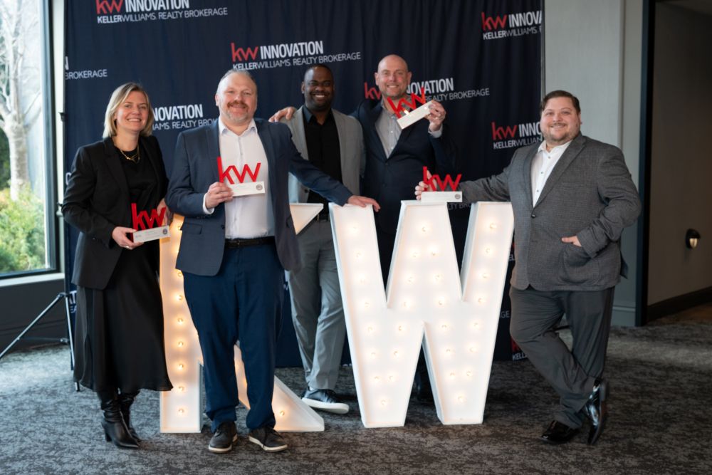 The best kitchener waterloo and guelph agents posing around a massive KW